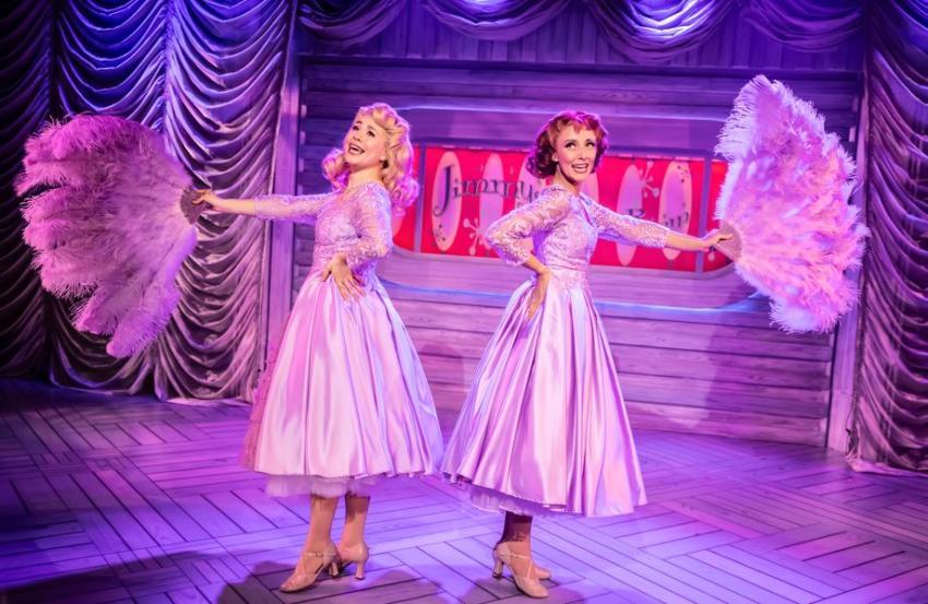 Two women in silver dresses performing White Christmas